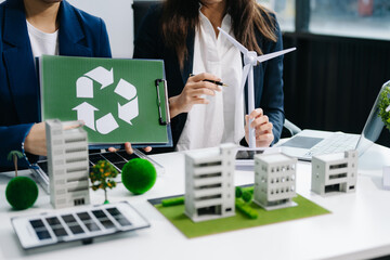 business team people planning and discussing on recycle reduce reuse policy symbol in office room. Green business company and Solar Energy Environment city Concept.