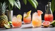 Refreshing summer cocktails with bitters on the table with lime, grapefruit and pineapple