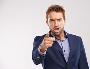 Poster - Entrepreneur, man and shout with pointing in studio white background to blame, angry and disappointed. Portrait, businessman and furious or upset in suit and professional with start up company