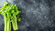 Fresh celery on dark background. The concept of healthy eating. Top view. Free space for text.