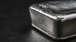 close-up up of a silver ingot bar on black background