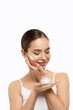Beauty Skin Woman Natural Makeup Face Cosmetic Concept.Beautiful Portrait Of Female Face Holding And Applying Cosmetic Cream. Skin Care.