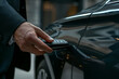 Close up of a businessman opening the door to a luxury car with a remote control key