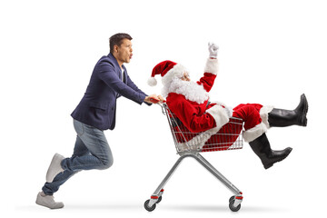 Wall Mural - Young man pushing Santa Claus inside a shopping cart