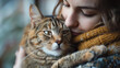 Tender interaction between a woman and her beloved tabby cat at home.