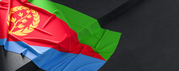 Wall Mural - Flag of Eritrea. Fabric textured Eritrea flag isolated on dark background. 3D illustration