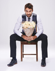 Sticker - Studio, portrait and man with chair, bouquet and date for style and fashion. Gentleman, designer and romance with flowers, confidence and proud ambition with suit isolated on white background