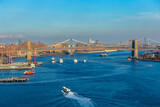 Fototapeta  - New York City skyline and Hudson River as seen from Helicopter at sunset, One World Trade Center view. Aerial view of Manhattan, Battery Park, freedom tower, Downtown, Finance center