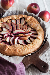 Wall Mural - Sweet galette with apples and elder berries on wooden board.