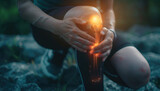 Fototapeta  - A person is massaging their knee with an animated glowing joint in the background, symbolizing pain relief and self care for people suffering from joint pain