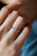 © S photographer - Close-up of a diamond ring on a woman's ring finger.