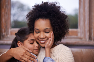 Mother, child and hug on sofa in home for weekend relaxing or holiday bonding, love or support. Woman, daughter and embrace connection in apartment living room for vacation care, youth or parenting