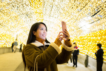 Canvas Print - Woman use mobile phone to take photo in city at night