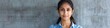 Indian young business woman wear blue shirt looking at camera isolated on grey