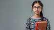 Serious focused indian young woman college university school student wear glasses hold read book