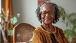 © ORG - A confident and smiling senior black woman stands in the room.