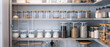 Neatly organized pantry shelves with labeled jars and containers.