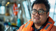 A Pacific Islander man with Down syndrome expressing curiosity and interest while working as a marine biologist on a research boat. Learning Disability