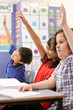 © Austockphoto - Students with their hands up in the classroom