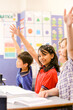 © Austockphoto - Happy students in the classroom wanting to answer a question