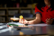 © Austockphoto - girl student at her desk working on maths problems using dice