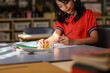 © Austockphoto - Student using dice to solve maths problems