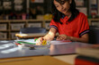 © Austockphoto - girl student at her desk working on maths problems using dice