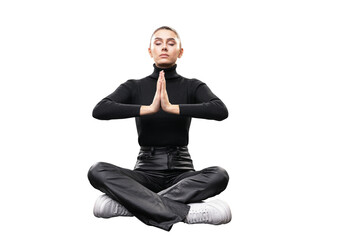 Canvas Print - A young woman in black clothing seated in a meditative pose with hands together, isolated on white background