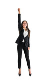 Fototapeta Panele - A young woman posing as a superhero with one arm raised triumphantly, dressed in business attire, against a white background