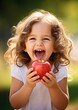 © Mike Walsh - Happy Young Child Holding a Juicy Red Apple About to Bite
