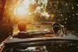 Just Married Couple Driving Away in a Vintage Convertible at Sunset