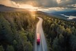 Sunset over a forest-lined highway with a truck driving, showcasing serene transportation amidst nature.