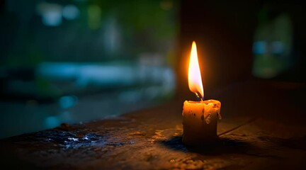 Wall Mural - a lit candle sitting on top of a wooden table