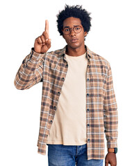Wall Mural - handsome african american man with afro hair wearing casual clothes and glasses pointing with finger