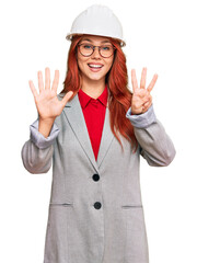 Poster - Young redhead woman wearing architect hardhat showing and pointing up with fingers number eight while smiling confident and happy.