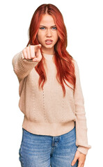 Sticker - Young redhead woman wearing casual winter sweater pointing displeased and frustrated to the camera, angry and furious with you