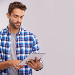 Poster - Typing, tablet and man with connection, internet and digital app on a grey studio background. Person, mockup space and model with technology or communication with social media and website information
