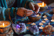 a person's hands arranging crystals and candles on an altar