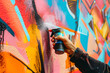 a street artist's hands spraying vibrant colors onto a blank wall