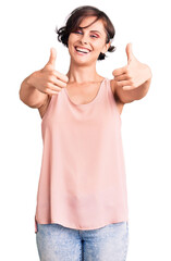 Sticker - Beautiful young woman with short hair wearing casual style with sleeveless shirt approving doing positive gesture with hand, thumbs up smiling and happy for success. winner gesture.