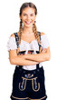© Krakenimages.com - Beautiful caucasian woman with blonde hair wearing octoberfest traditional clothes happy face smiling with crossed arms looking at the camera. positive person.