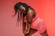 © gstockstudio - Happy plus size woman in sportswear exercising and looking confident on colorful background