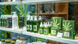 
Cannabis products with the characteristic branding of cannabis leaves on a shelf of dispensary, shop, pharmacy. Medical marijuana and CBD products