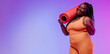 © gstockstudio - Active young voluptuous woman in sportswear carrying exercise mat and smiling on pink background