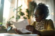 Portrait of an elder woman reading a newspaper indoors
