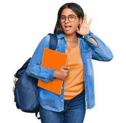 Sticker - Young latin girl wearing student backpack and holding books smiling with hand over ear listening an hearing to rumor or gossip. deafness concept.