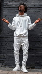 Wall Mural - Portrait of African attractive man against background of black brick wall