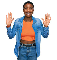 Sticker - Young african american woman wearing casual clothes showing and pointing up with fingers number ten while smiling confident and happy.