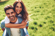 man and woman are smiling and hugging each other in grassy field