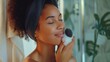The woman uses a facial brush to cleanse her face, effectively removing dirt, oil, and impurities for a fresh and rejuvenated complexion.
